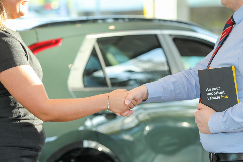 Handshake with customer in front of car