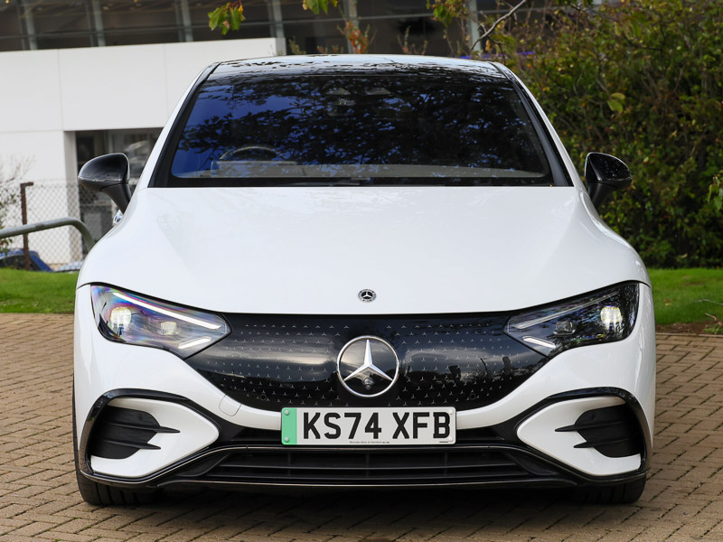 A white Mercedes-Benz EQE sitting head on