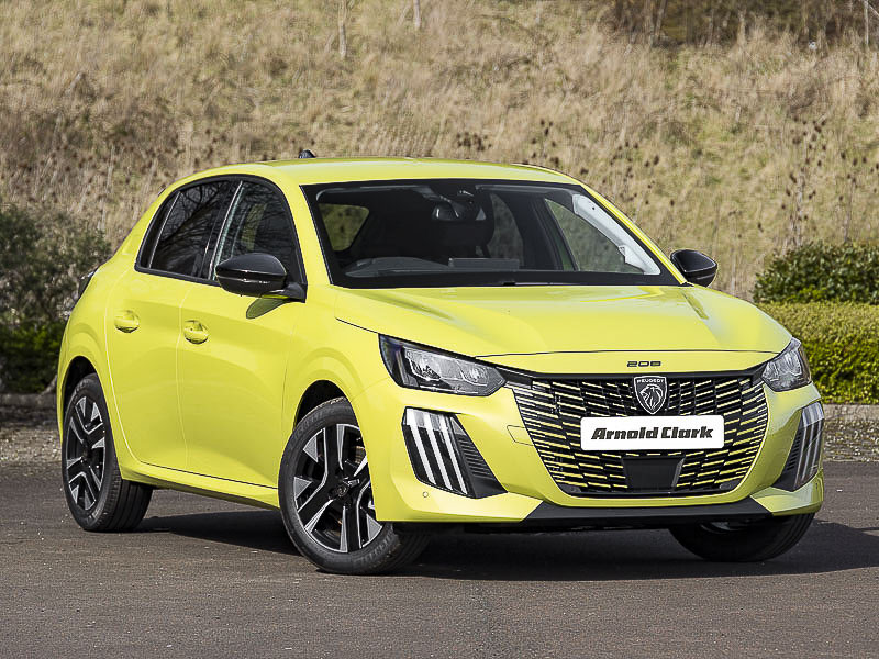 Yellow Peugeot 208 in front of a grassland background