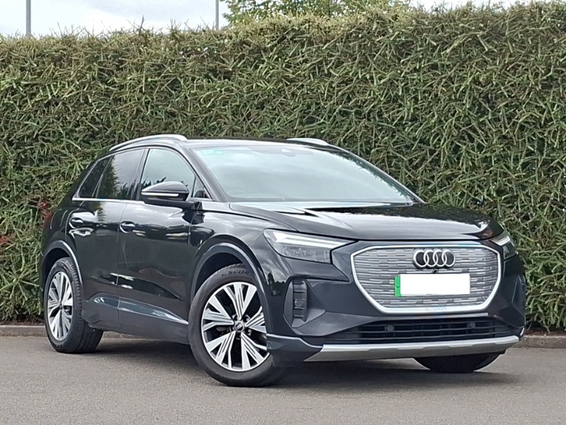 Black Audi Q4 E-tron in front of hedge background