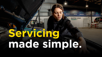 Technician working on car, text servicing made simple.
