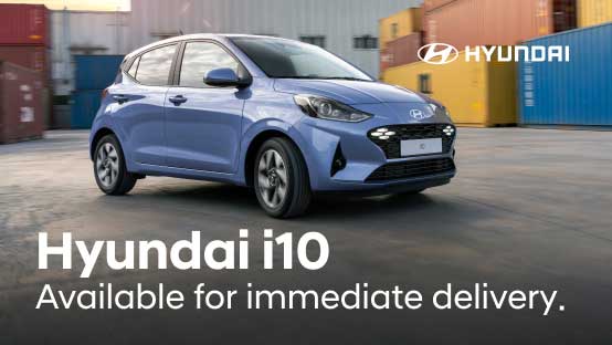Side view of Hyundai i10 with "Available for immediate delivery." text