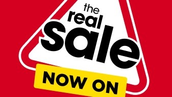 The Real Sale in a red triangle with Now On in yellow box
